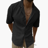 Short-sleeve men's shirt with open collar and textured surface